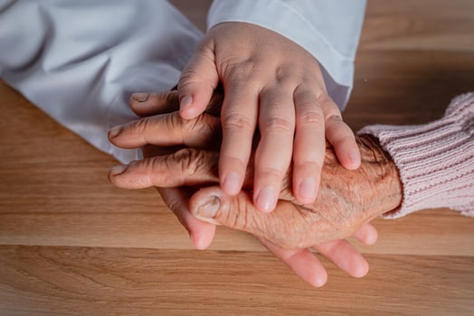 The doctor shook the patient's hand as a sign of encouragement. photo