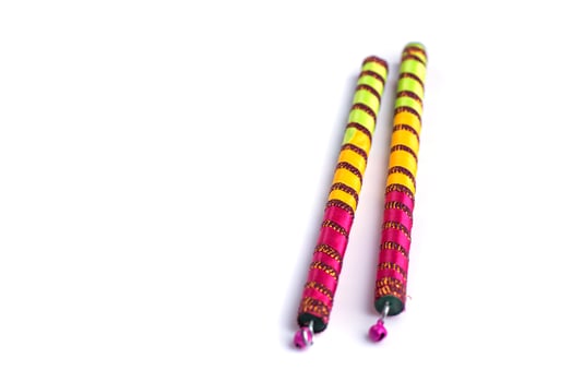 Two colorful sticks with a pink and yellow design photo