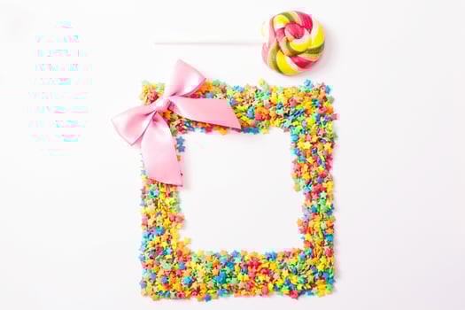 Colorful frame candy, lollipop and sweets isolated on white background. Top view. Selective focus. photo