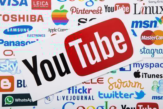 KIEV, UKRAINE - MARCH 10, 2017. YouTube, twitter, apple, pinterest logotype printed on paper. YouTube is a video-sharing website. Top view and mock up. photo