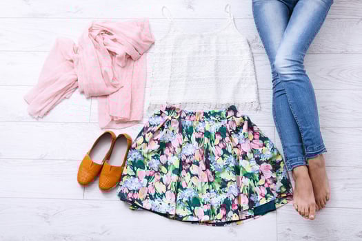 Stylish outfit with accessories and female legs on white wooden background. Top view and copy space photo