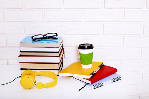 Workspace and education accessories on the table. Cup of coffee, books, glasses, notebooks, headphones. Stem education photo