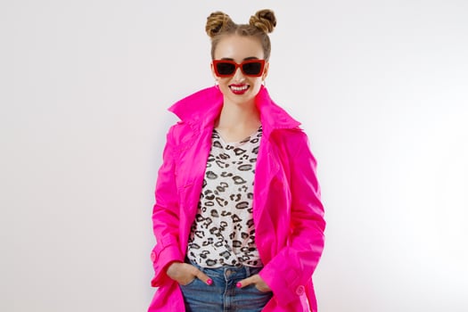 Happy, shock, excited woman face closeup. Girl in bright pink autumn clothes, red sunglasses isolated on white background, copy space. Beautiful female surprised, cheerful. Fun funny model screaming photo