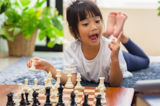 little girl having online chess lesson, e-education, distance learning photo