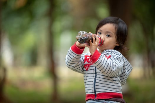 little girl drink cola photo