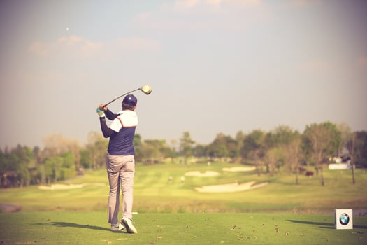 Golfers hit sweeping golf course in the summer.Vintage color photo
