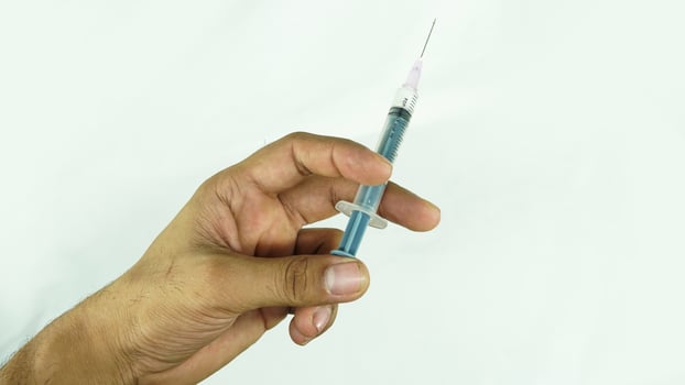 injection in hand on white background photo