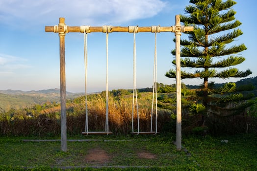 Swings Set with Mountain and Blue Sky photo