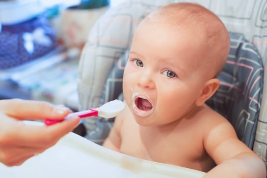 Little baby infant is eating its food. baby food, formula, baby care photo