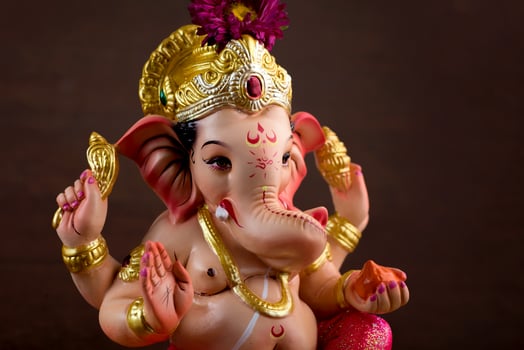 Hindu God Ganesha. Ganesha Idol on dark wooden background. photo