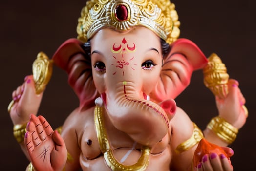 Hindu God Ganesha. Ganesha Idol on dark wooden background. photo