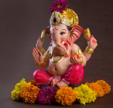 Hindu God Ganesha. Ganesha Idol on dark wooden background. photo