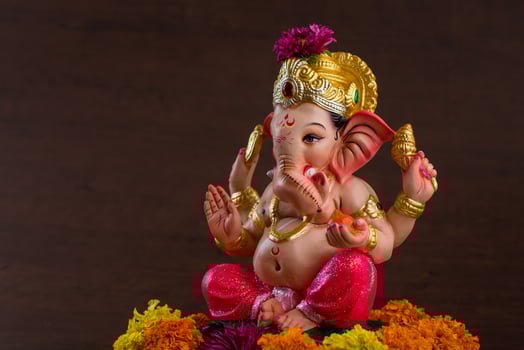 Hindu God Ganesha. Ganesha Idol on dark wooden background. photo