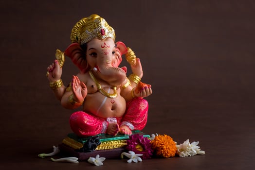 Hindu God Ganesha. Ganesha Idol on dark wooden background. photo