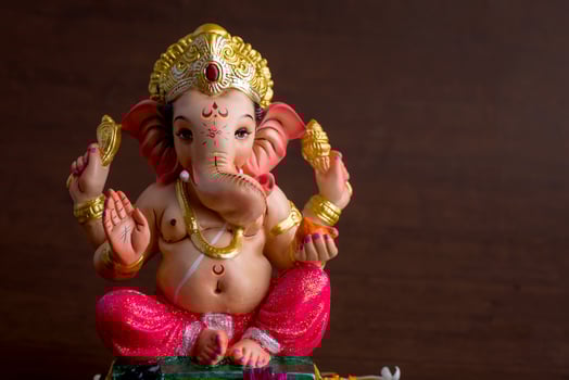 Hindu God Ganesha. Ganesha Idol on dark wooden background. photo