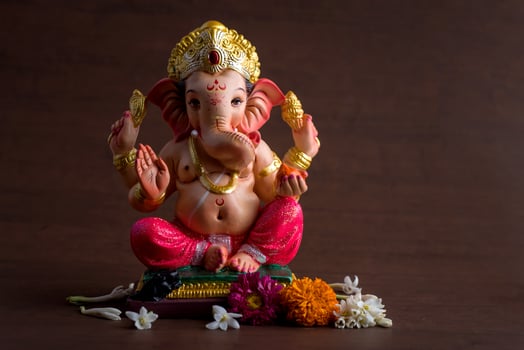 Hindu God Ganesha. Ganesha Idol on dark wooden background. photo