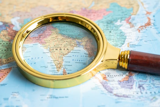 Bangkok, Thailand - January 20, 2022 India, Magnifying glass close up with colorful world map. photo