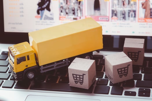 Logistics, and delivery service - Truck and paper cartons or parcel with a shopping cart logo on a laptop keyboard. Shopping service on The online web and offers home delivery. photo