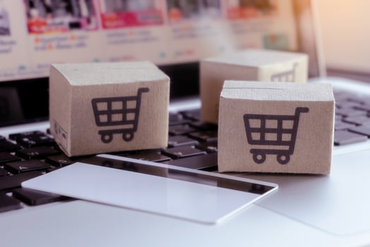 Online shopping. Credit card and cardboard box with a shopping cart logo on laptop keyboard. Shopping service on The online web. offers home delivery photo