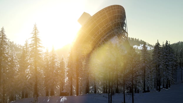 The observatory radio telescope in forest at sunset photo