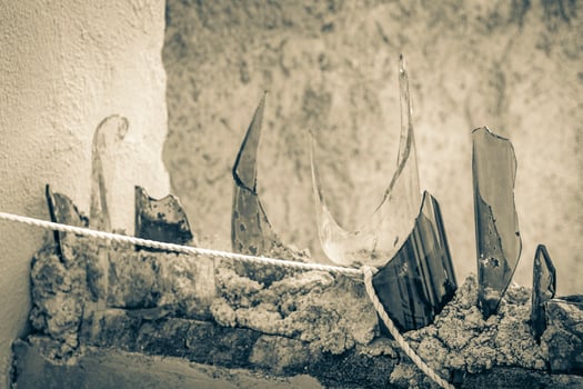 Dangerous wall with broken glass bottles Playa del Carmen Mexico. photo