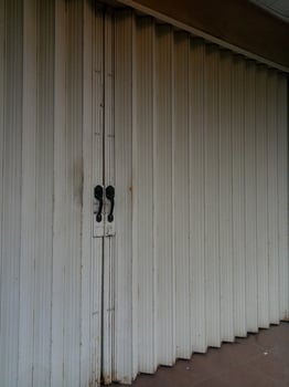 Dull and rusty white folding door photo