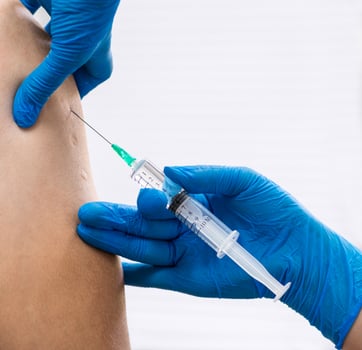 doctor gives an injection to the patient, closeup photo