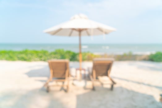 abstract blur umbrella with beach chair for background photo