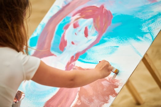 Amateur painter drawing picture on white canvas at outdoor art exercise, painting performance photo