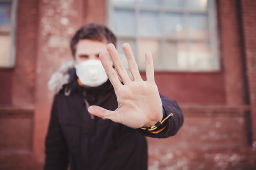 man in medical protective mask showing gesture stop photo