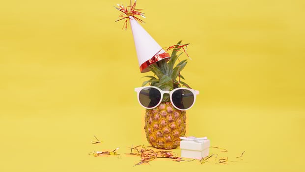 party theme pineapple fruit isolated on yellow background photo
