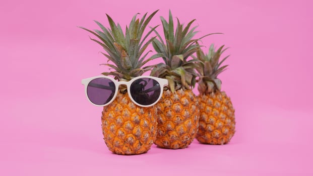 lined pineapple fruit isolated on pink background photo
