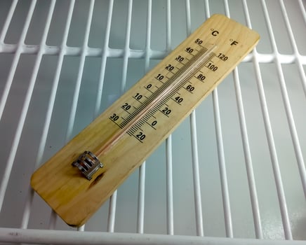 Analog thermometer. closeup. Fridge thermometer. Food, chemical or reagent safety. Refrigerator temperature monitoring device. Mercury thermometer. photo