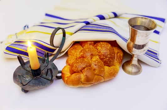 shabbat image. challah bread, wine and candelas on wooden table. photo