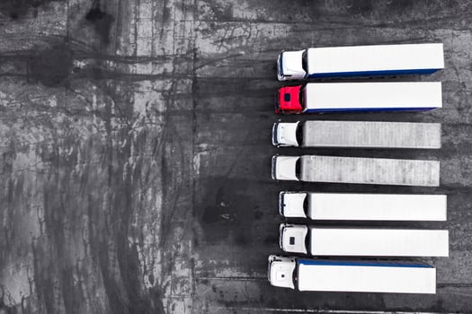 Trucks stand in a row on the asphalt background top view photo