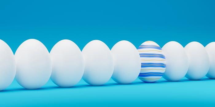 Easter Blue ornate egg around white eggs in row closeup. Blue painted egg in a row of the white eggs. Happy easter 3D rendering illustration. photo
