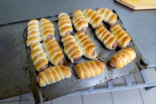 sausages in the dough on a baking sheet. photo
