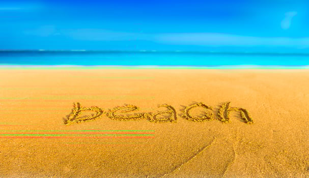 The yellow sand on the beach blue sea and the inscription beach photo