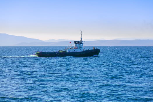 Thre View of a small tugboat in the sea photo