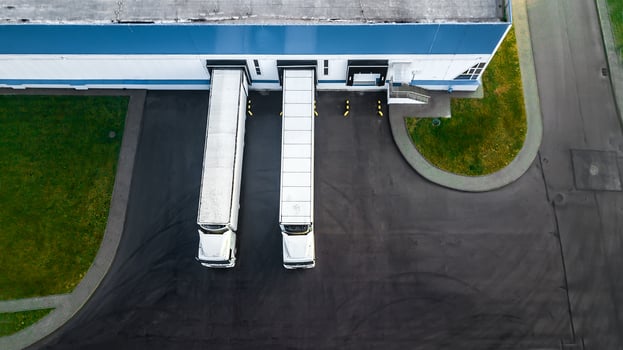trucks are loaded in a modern logistics center. aerial view. photo