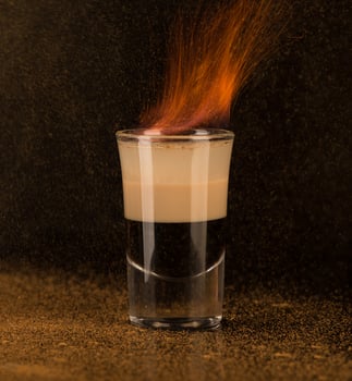 shot glass with alcohol on a dark background photo