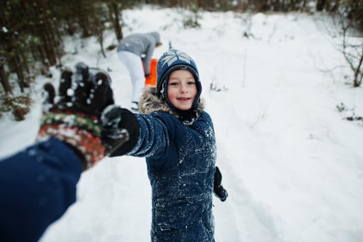 Father give high five for son in winter nature. Outdoors in snow. photo