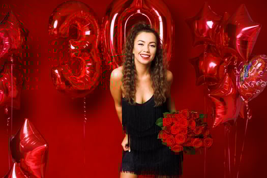 young adult woman on the background of red balloons photo