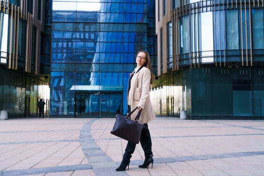 Successful happy business woman with  bag over office building background photo