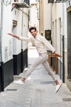 Young funny man jumping in the street. photo