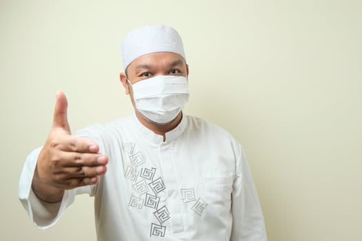 Portrait of young Asian muslim man wearing mask. photo