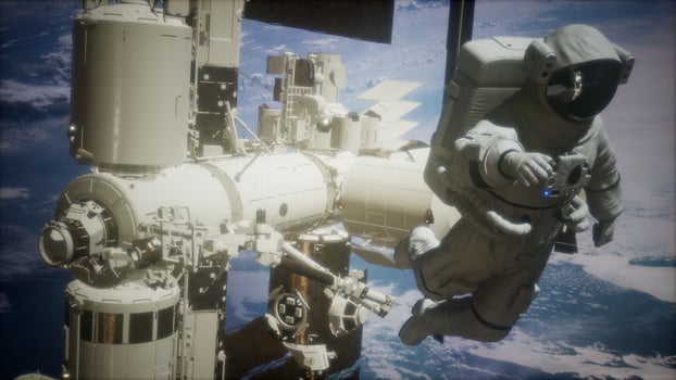 International Space Station and astronaut in outer space over the planet Earth photo
