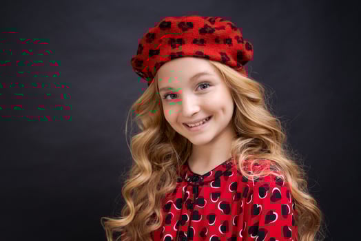 French fashion icon. Happy child wearing french red beret and dress on black photo
