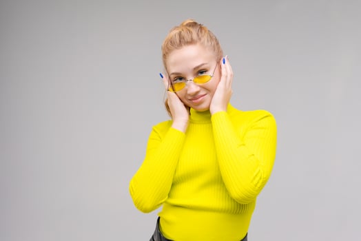 Portrait an attractive stunning cheerful slender girl, posing in bright yellow photo