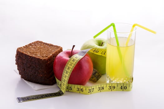 Rye bread apples and juice in  glass on a white background with a measuring tape photo